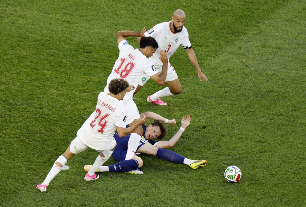  
Scotland's Scott McTominay in action with Morocco's Chadi Riad, Neil El Aynaoui and Noussair Mazraoui  