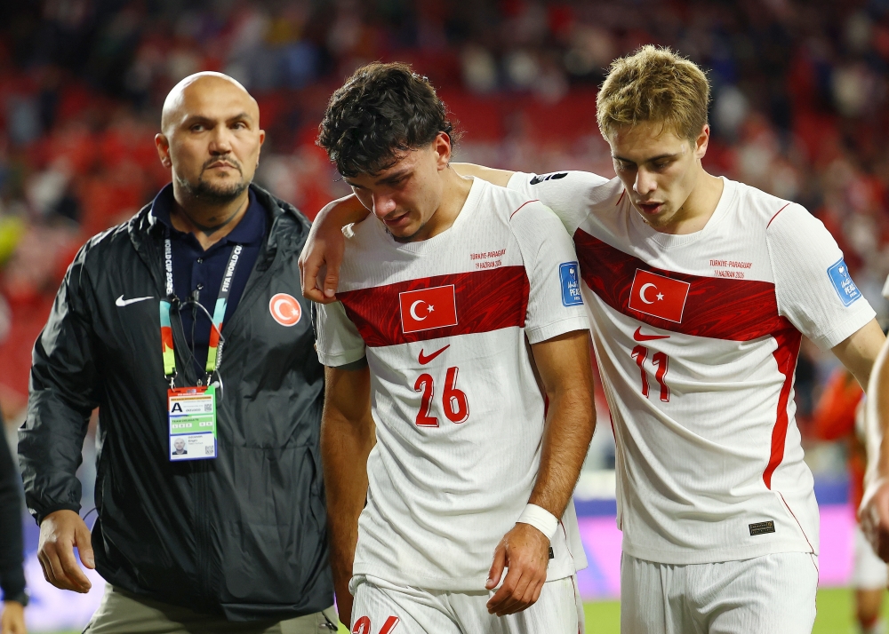  
Turkey's Can Uzun and Kenan Yildiz look dejected after the match  