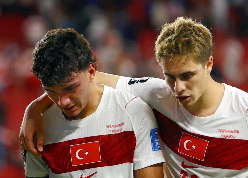  
Turkey's Can Uzun and Kenan Yildiz look dejected after the match 