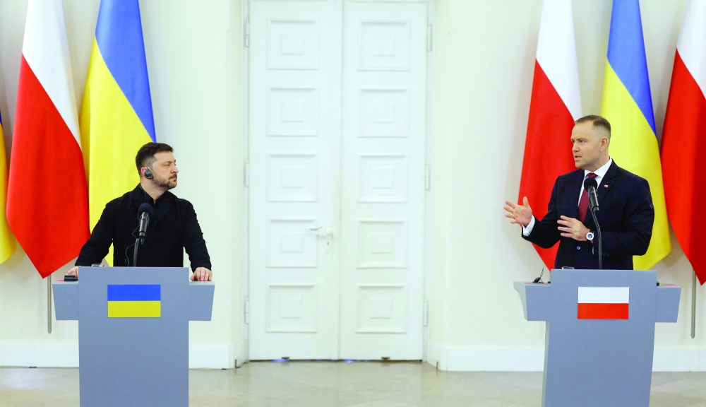 Poland's President Karol Nawrocki (R) and Ukraine's President Volodymyr Zelensky address a joint press conference following their talks. — AFP file photo 