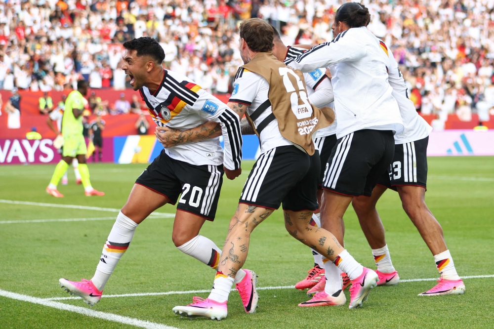 Germany's #20 Nadiem Amiri (L) and teammates celebrate second goal. — AFP