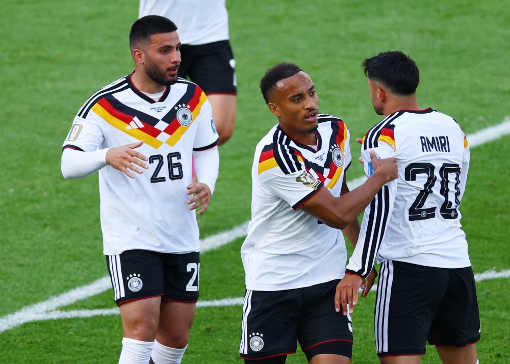  
Germany's Deniz Undav celebrates scoring first goal with Jamie and Nadiem. — Reuters