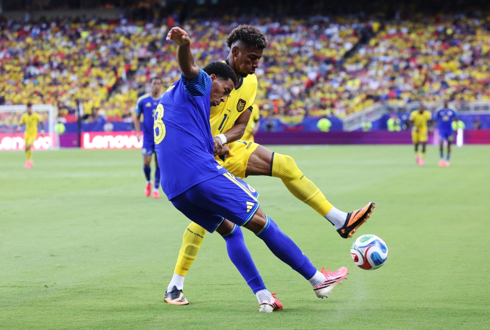  
Curacao's Livano Comenencia in action with Ecuador's Kevin Rodriguez. — Reuters