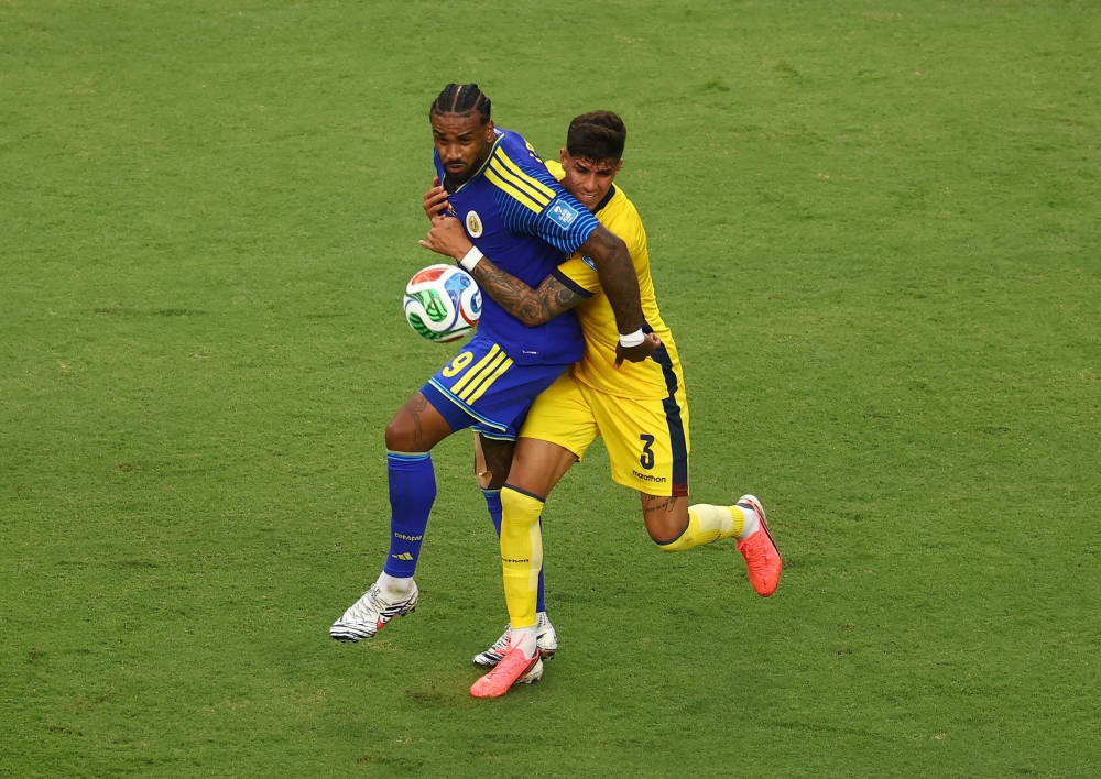  
Curacao's Jorgen Locadia in action with Ecuador's Piero Hincapie. — Reuters