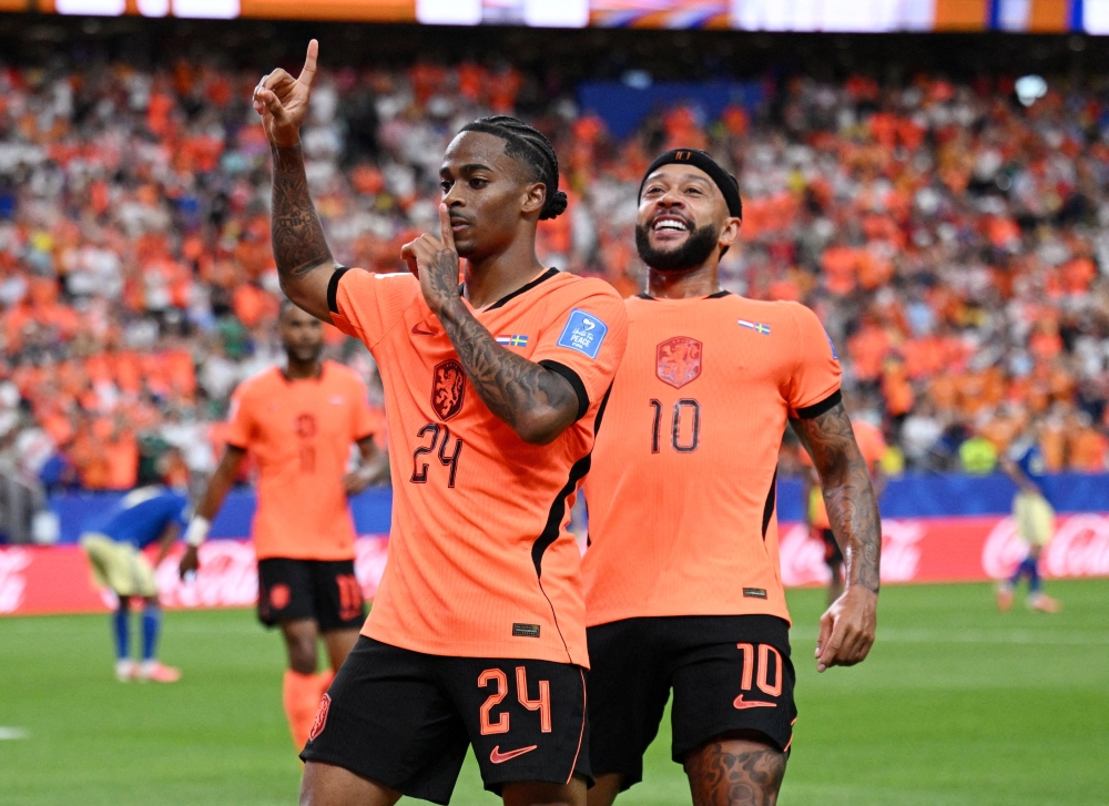 v
Netherlands' Crysencio Summerville celebrates scoring their fifth goal with Memphis Depay 