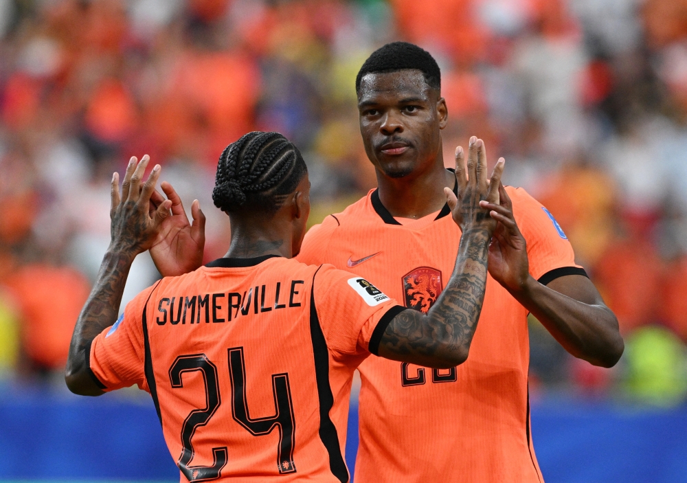  
Netherlands' Crysencio Summerville celebrates scoring their fifth goal with Denzel Dumfries  