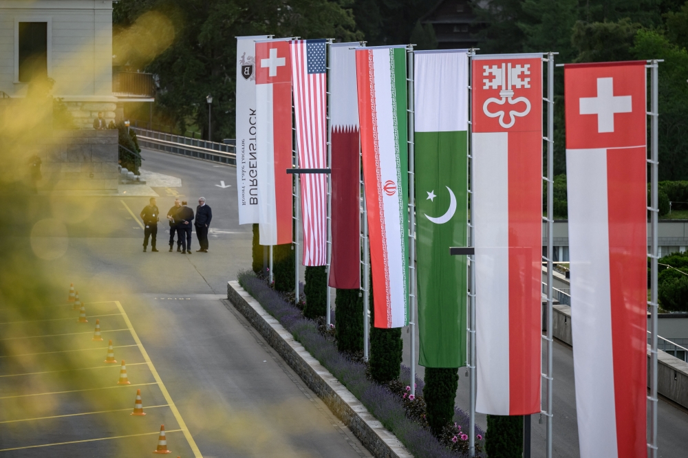 Flags of Switzerland, the United States, Qatar, Pakistan and the local Swiss canton of Nidwalden are photographed at the Burgenstock luxury hotel complex overlooking Lake Lucerne, Switzerland, on June 21, 2026, ahead of high-level talks aimed at advancing a deal to end the Middle East conflict. 