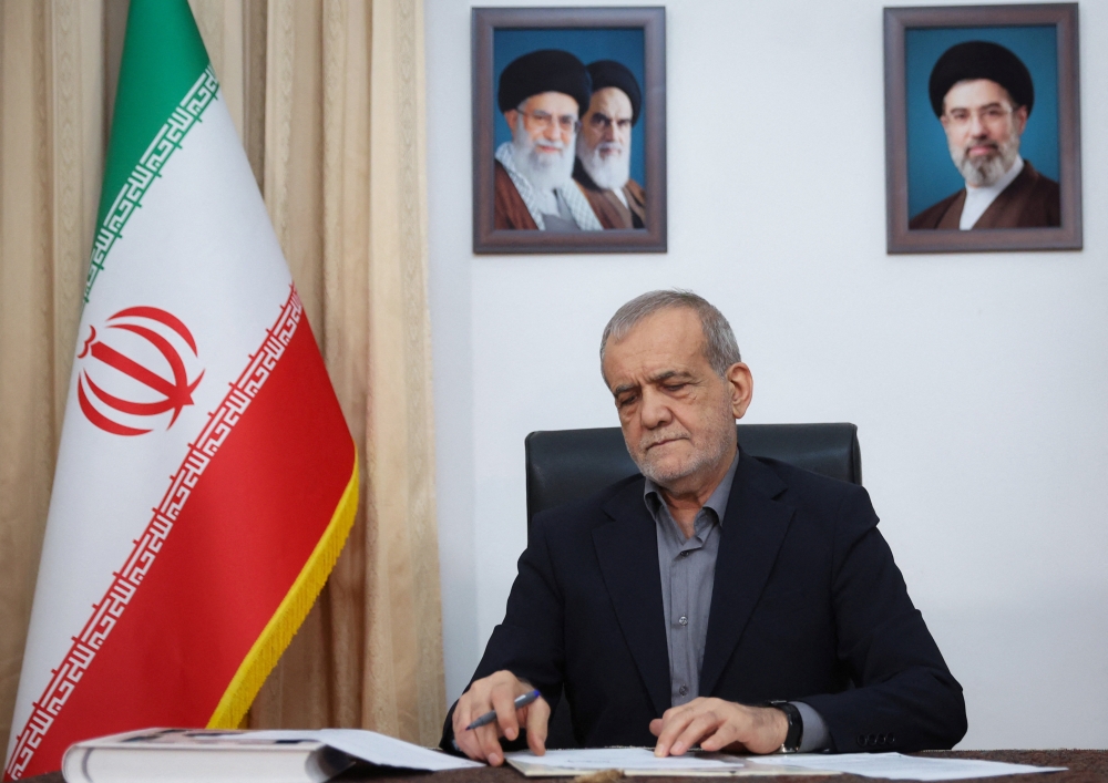 Iranian President Masoud Pezeshkian signs the document of U.S. Memorandum of Understanding in Tehran, Iran, June 18, 2026.