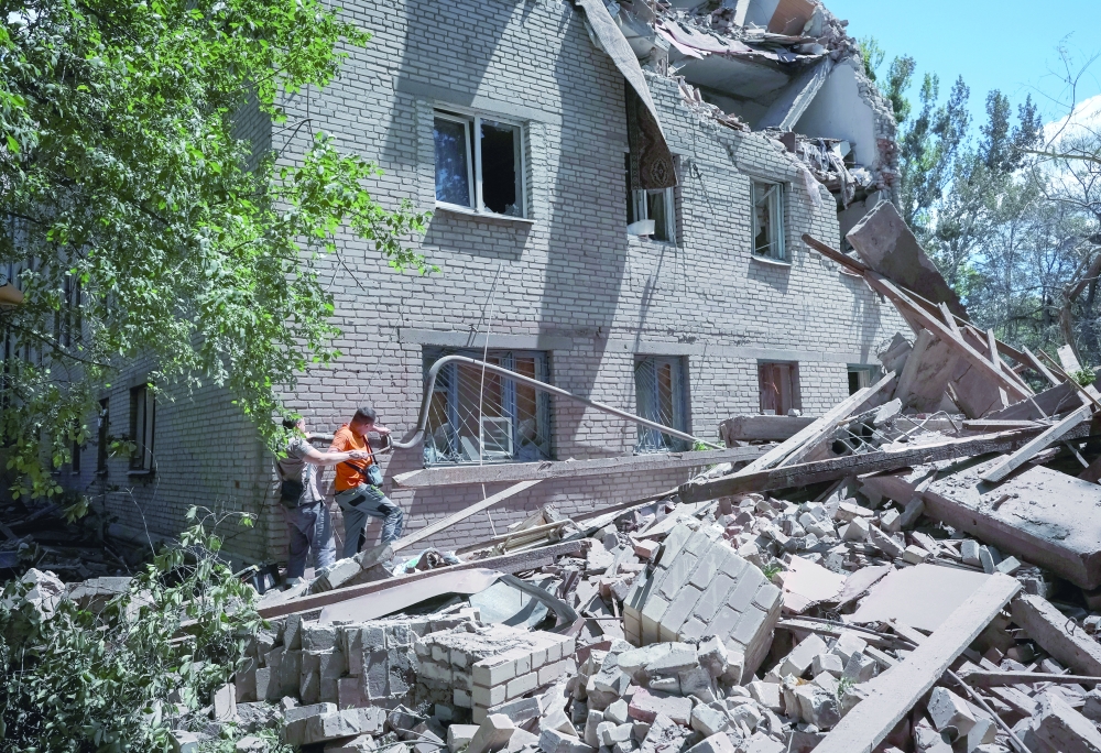 Residents inspect a damaged apartment building hit by Russian military strike in Donetsk region, Ukraine. — Reuters 