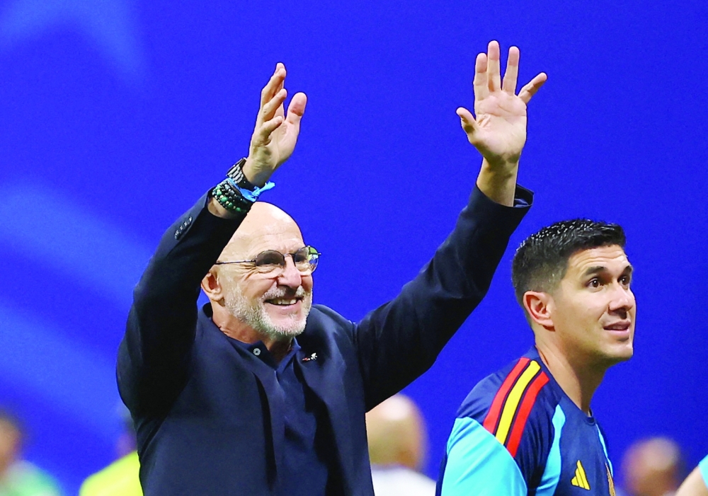  
Spain coach Luis De La Fuente salutes their fans. — Reuters