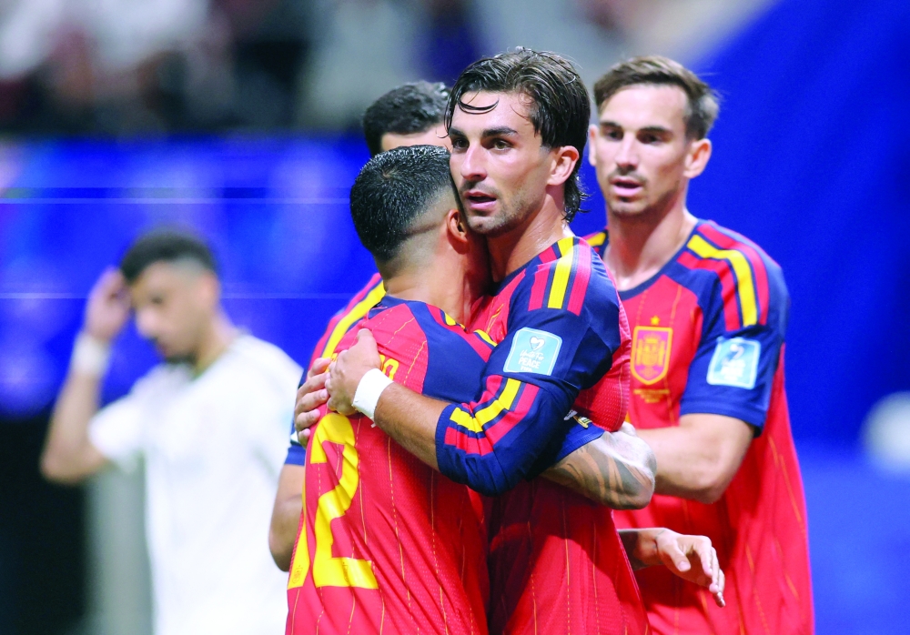  
Spain's Ferran Torres celebrates with Pedro Porro after scoring a goal. — Reuters