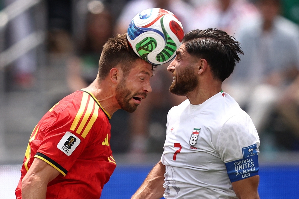  
Belgium's Brandon in action with Iran's Alireza. — Reuters