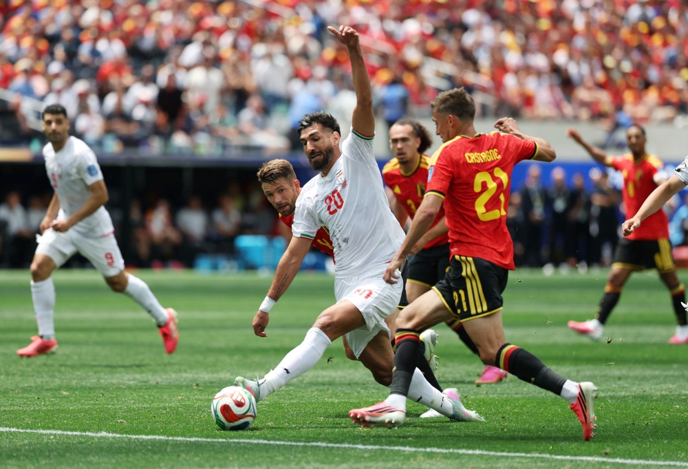  
Iran's Shahriyar in action with Belgium's Brandon and Timothy. — Reuters