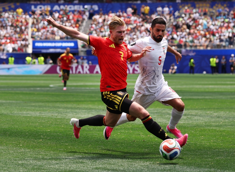  
Belgium's Kevin in action with Iran's Milad. — Reuters