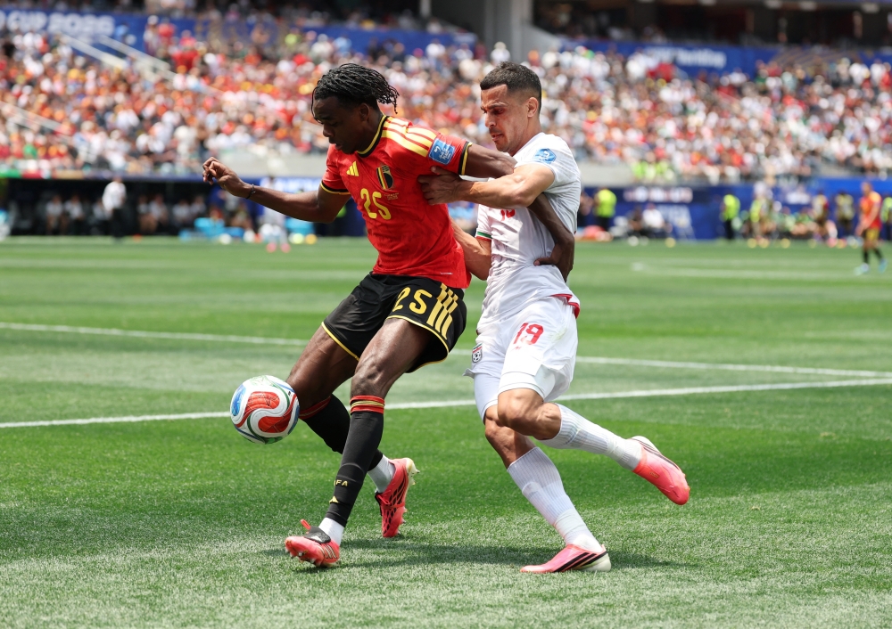  
Belgium's Nathan in action with Iran's Ali. — Reuters  