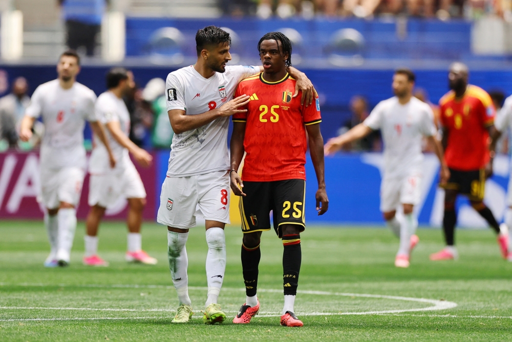  
Iran's Mohammad Mohebbi talks to Belgium's Nathan Ngoy. — Reuters