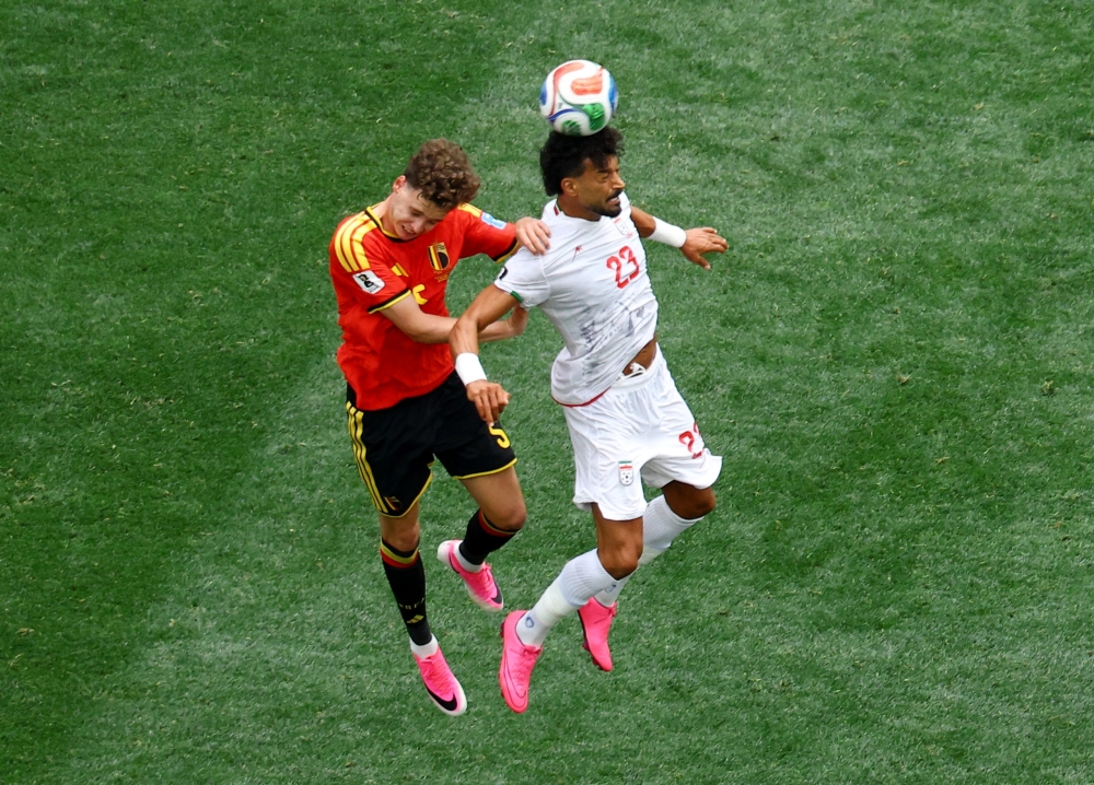  
Iran's Ramin Rezaeian in action with Belgium's Maxim De Cuyper. — Reuters