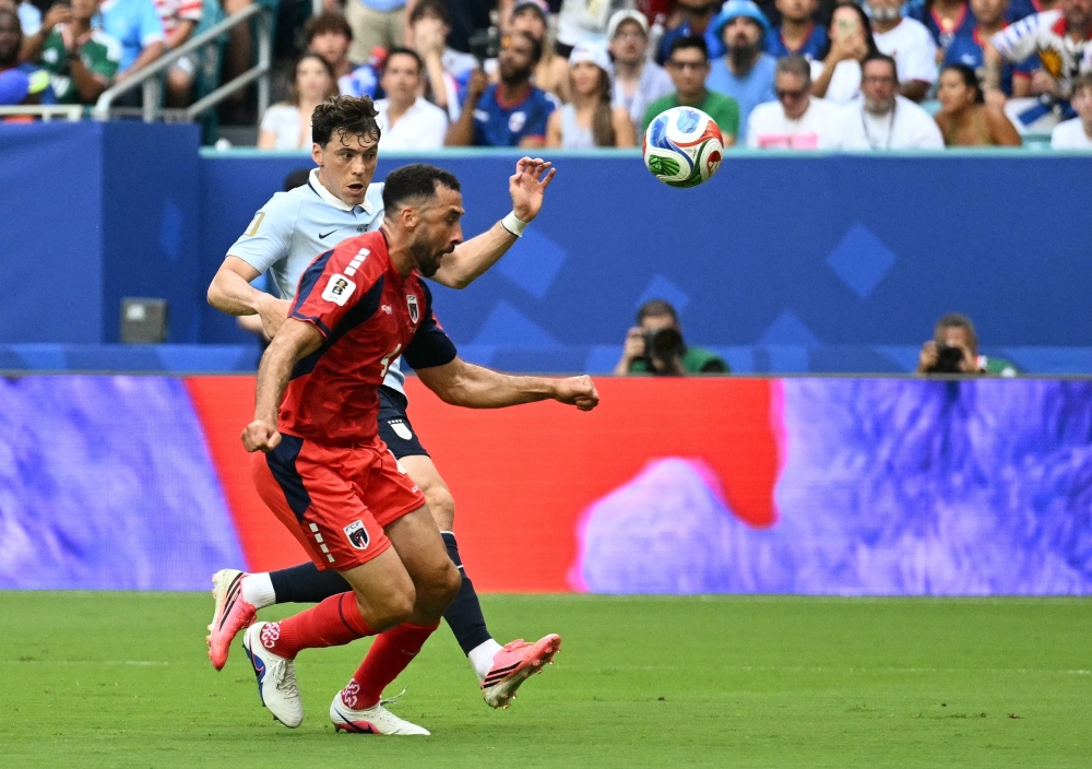 Uruguay's #21 Vinas and Cabo Verde's #04 Pico Lopes. — AFP