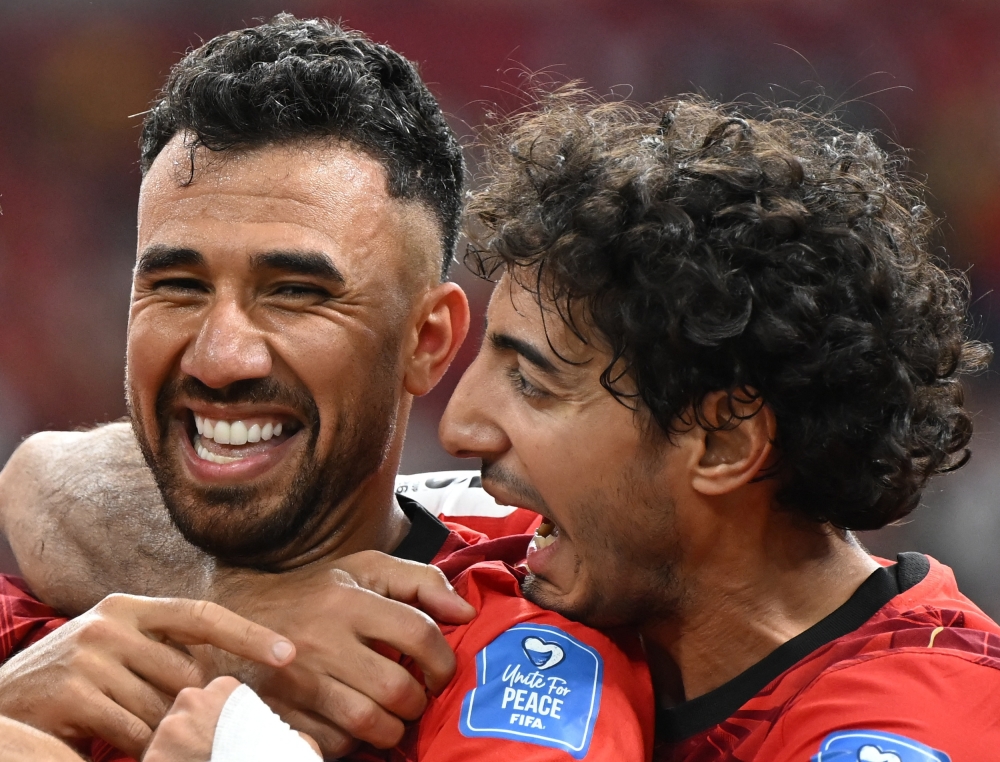  
Egypt's Trezeguet celebrates scoring their third goal with Hany. — Reuters 