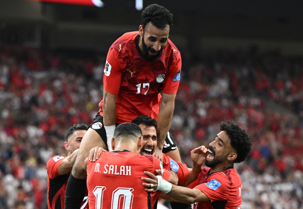  
Egypt's Mahmoud Trezeguet celebrates scoring their third goal with teammates. — Reuters  