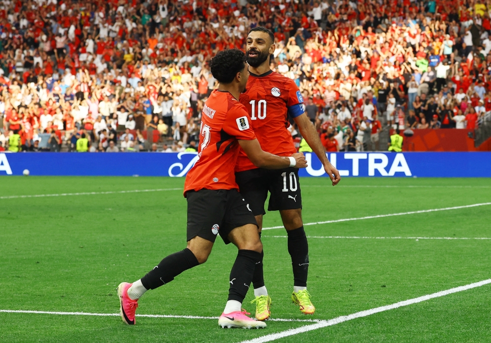  
Egypt's Mohamed Salah celebrates scoring their second goal with Omar Marmoush. — Reuters  