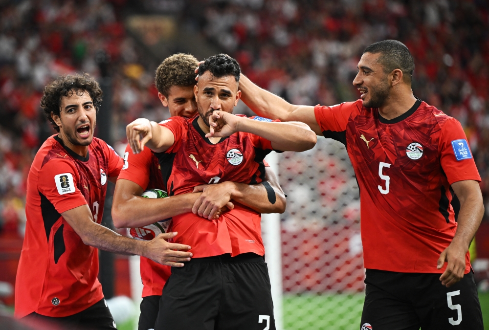  
Egypt's Mahmoud Trezeguet celebrates scoring their third goal with teammates. — Reuters