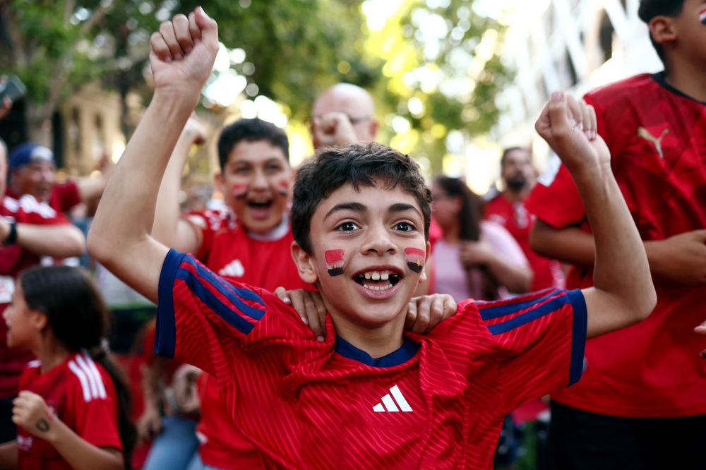 
Egypt fans celebrate at San Pedro Square in San Jose after Egypt's Mostafa Zico scores their first goal  