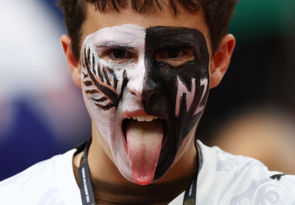  
New Zealand fan with their face painted fans inside the stadium before the match 