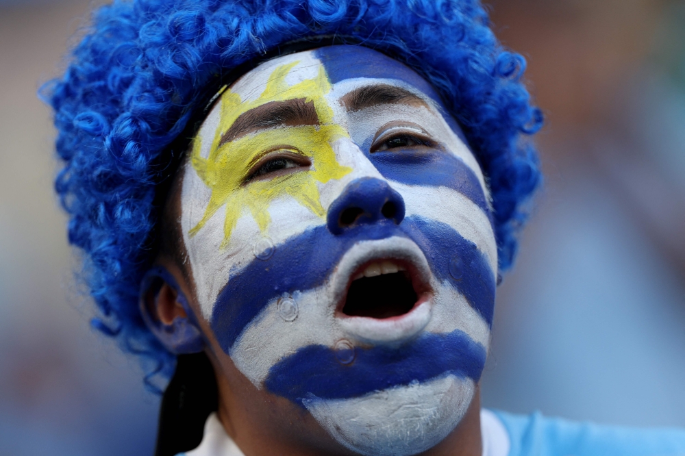 An Uruguayan fan cheers for his team 