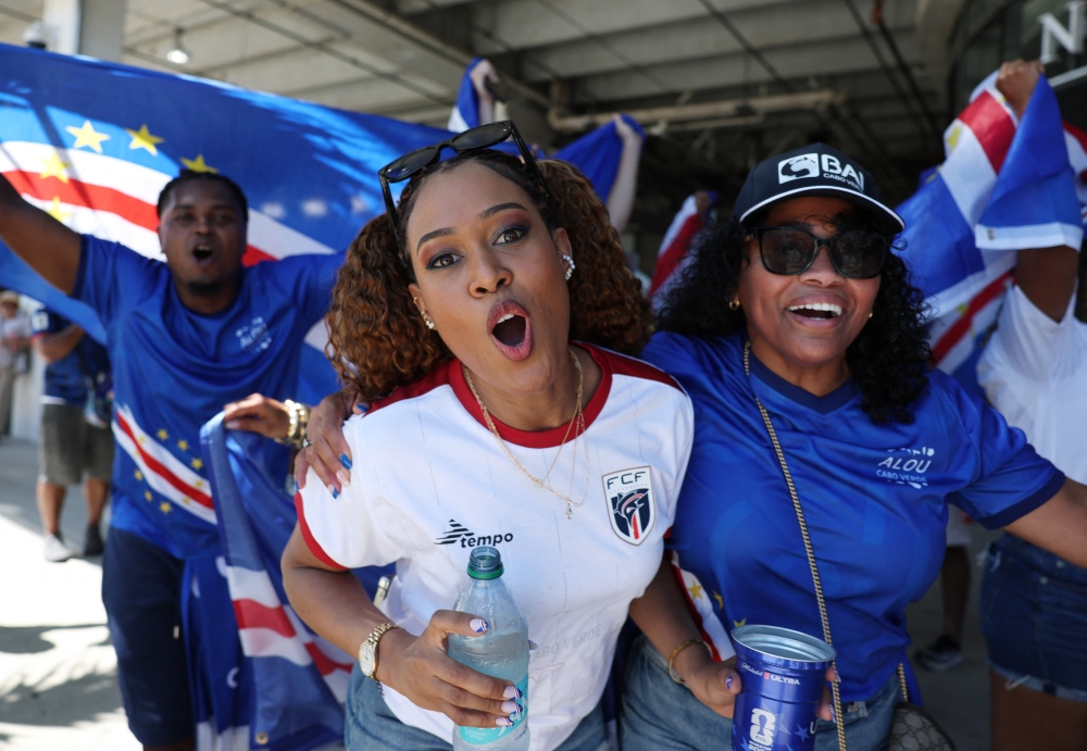  
Cape Verde fans pose for a photo outside the stadium before the match  