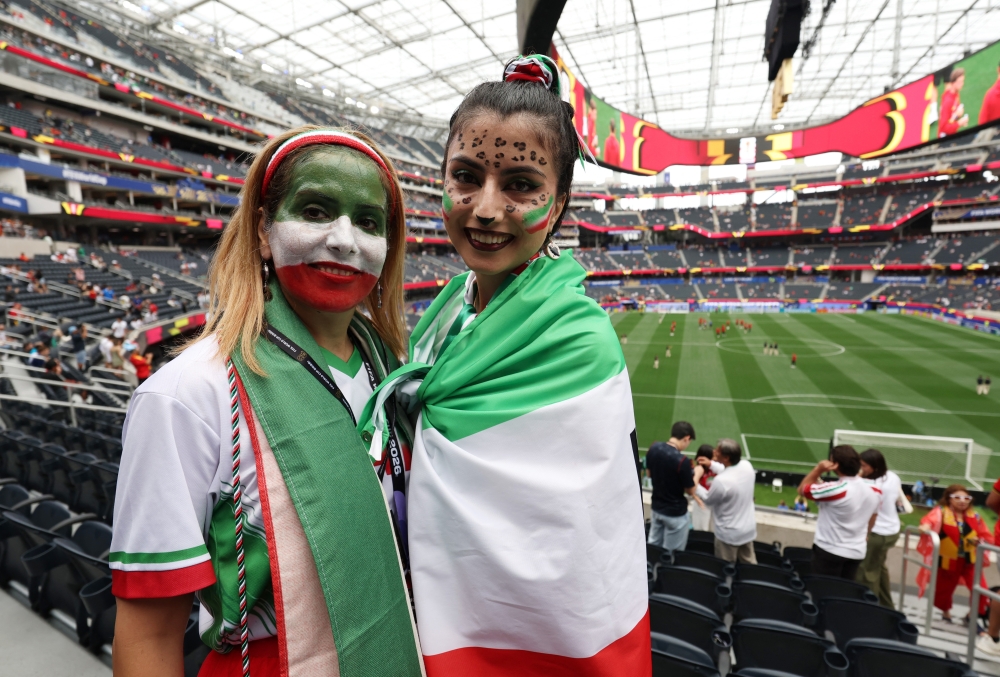  
Iran fans with their faces painted inside the stadium before the match 