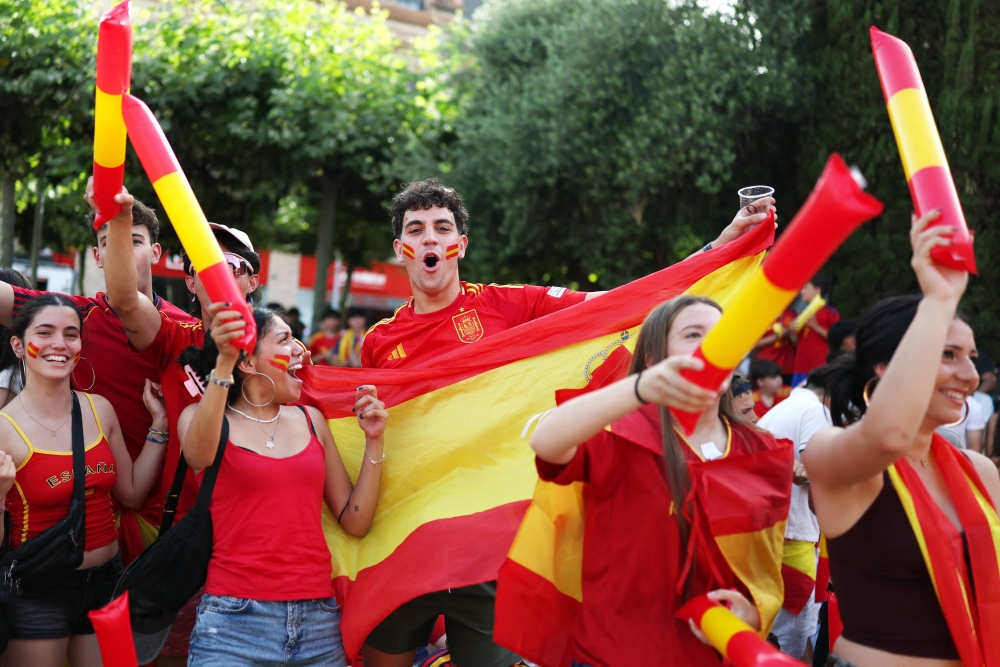  
Spain fans watching the match in Madrid celebrate their fourth goal, an own goal scored by Saudi Arabia's Hassan Altambakti  