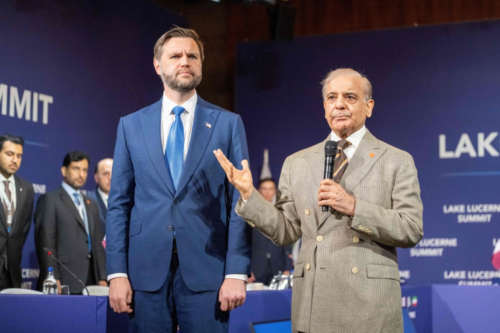 Pakistan's Prime Minister Shehbaz Sharif (R) speaks next to US Vice President JD Vance prior to a quadrilateral meeting between the United States