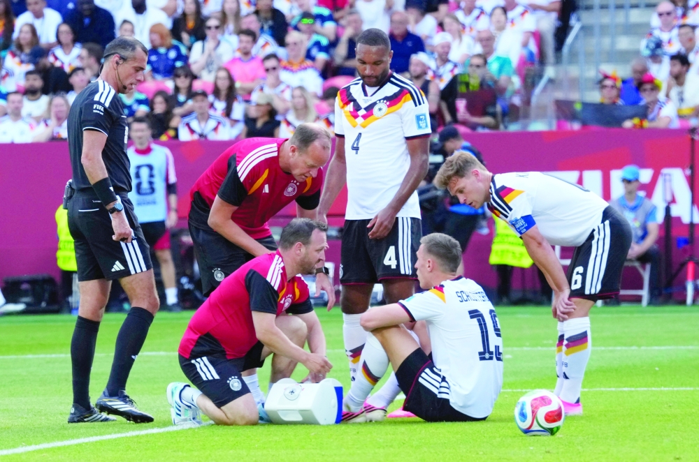 Germany's Nico Schlotterbeck receives medical attention after sustaining an injury. — Reuters