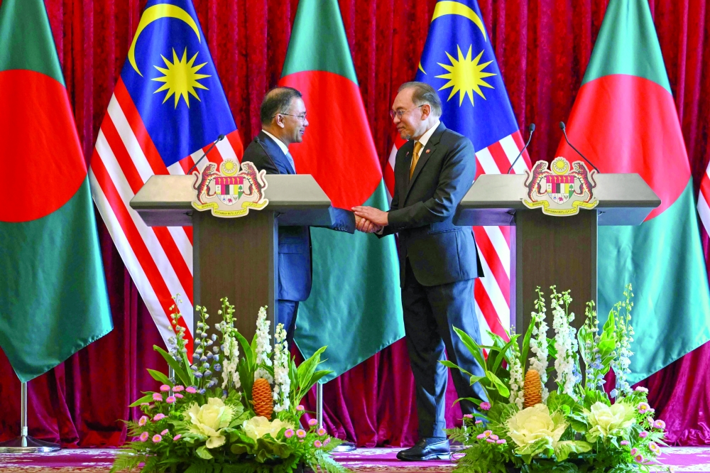 Bangladesh's PM Tarique Rahman (L) and Malaysia's PM Anwar Ibrahim shake hands during a press conference at the Federal Government office "Putra Perdana" in Putrajaya. — AFP