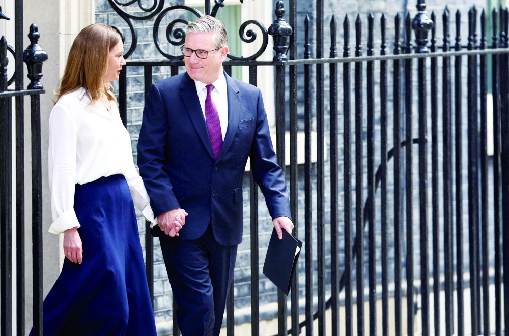 British Prime Minister Keir Starmer walks with his wife Victoria, on the day he announces the timeline for his resignation. - Rueters 