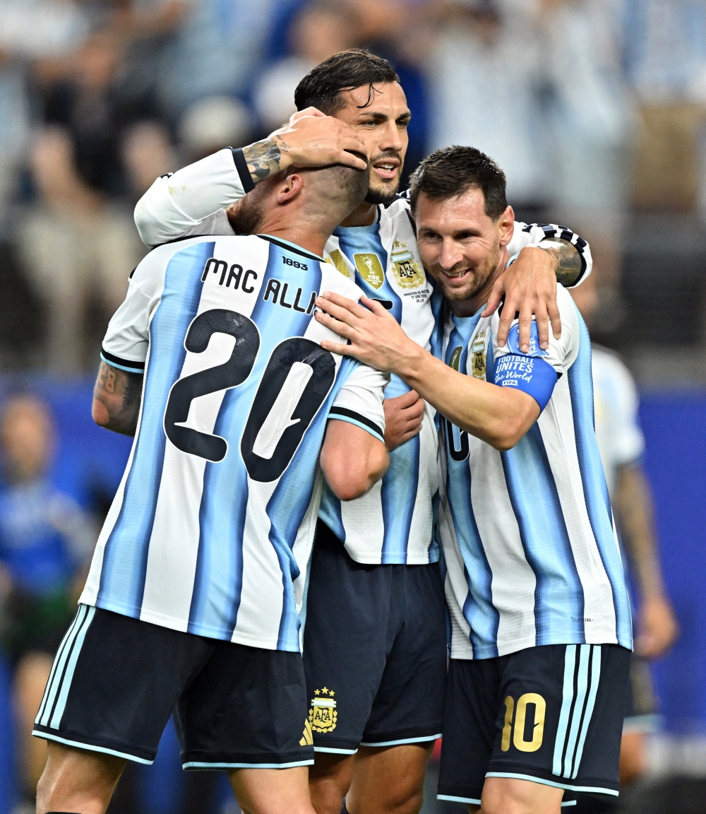  
Argentina's Lionel Messi, Leandro Paredes and Alexis Mac Allister celebrate after the match 