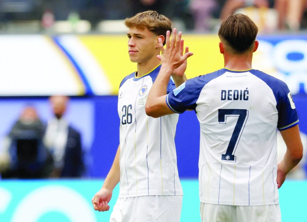  
Bosnia and Herzegovina's Ermin Mahmic with Amar Dedic. — Reuters 