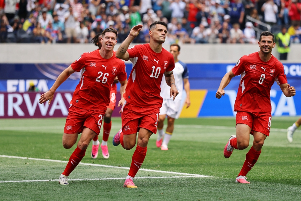  
Switzerland's Granit Xhaka celebrates scoring their fourth goal with Cedric Itten and Remo Freuler. — Reuters