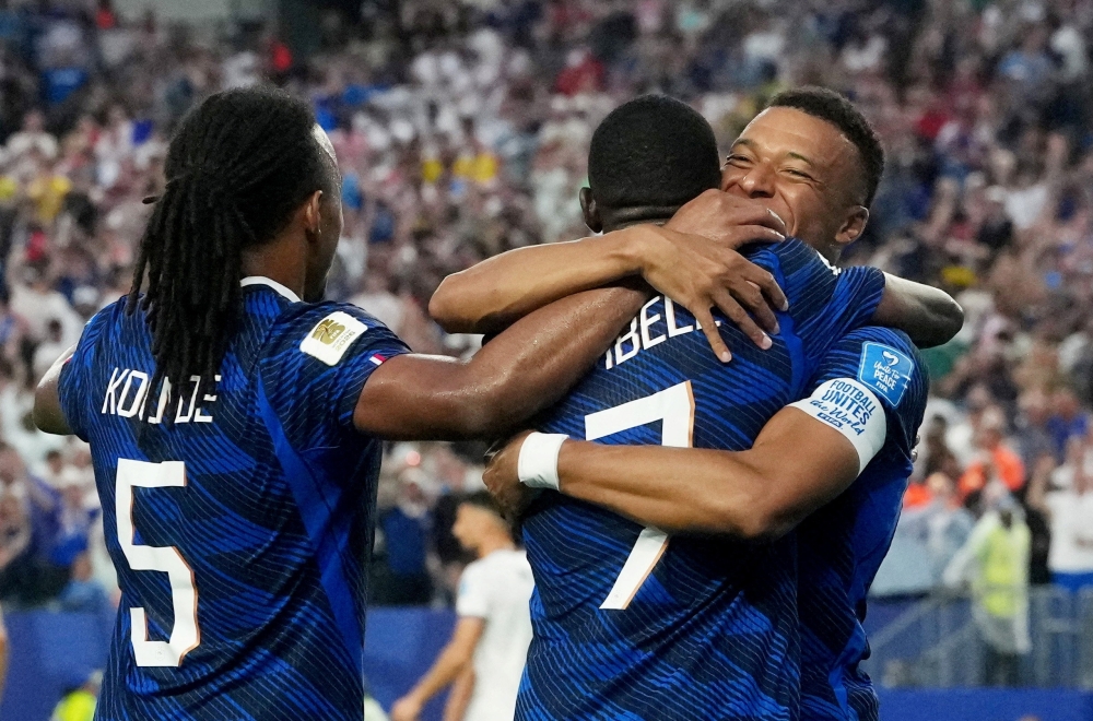  
France's Dembele celebrates scoring their third goal with Kounde and Mbappe. — Reuters
