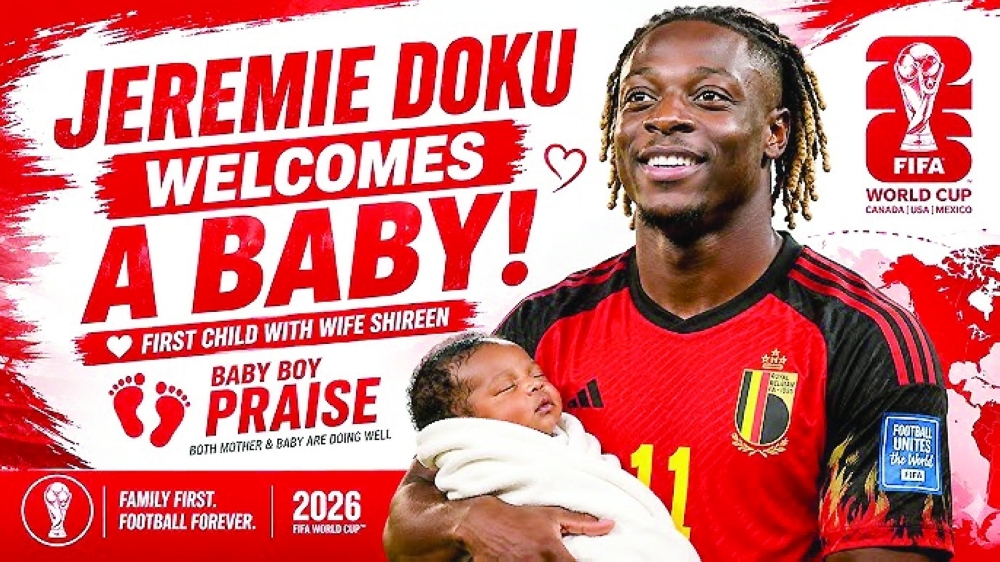 Belgian national team player Jeremy Doku holding his first child.