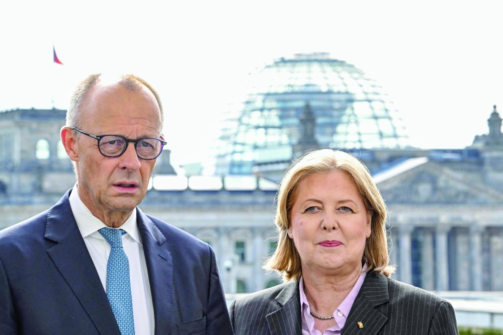 Germany's Chancellor Friedrich Merz (L) and German Minister for Labour and Social Affairs Baerbel Bas (R) speak after the 13-member pension reform commission at the chancellery in Berlin. — AFP