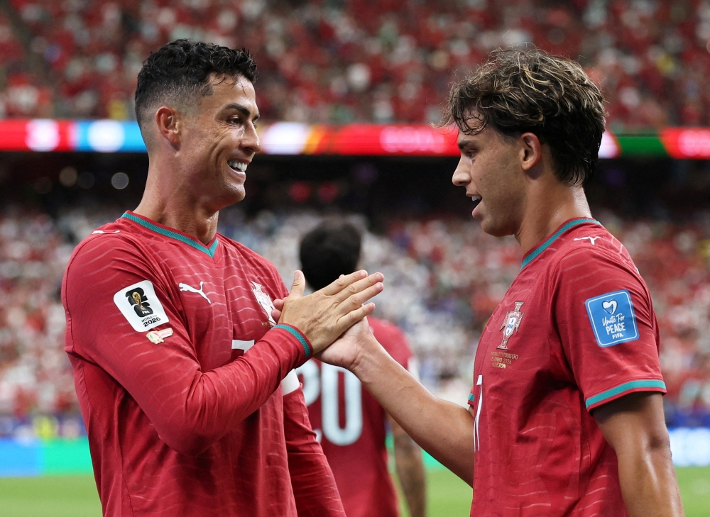  
Portugal's Ronaldo celebrates scoring their third goal with Joao Felix. — Reuters   