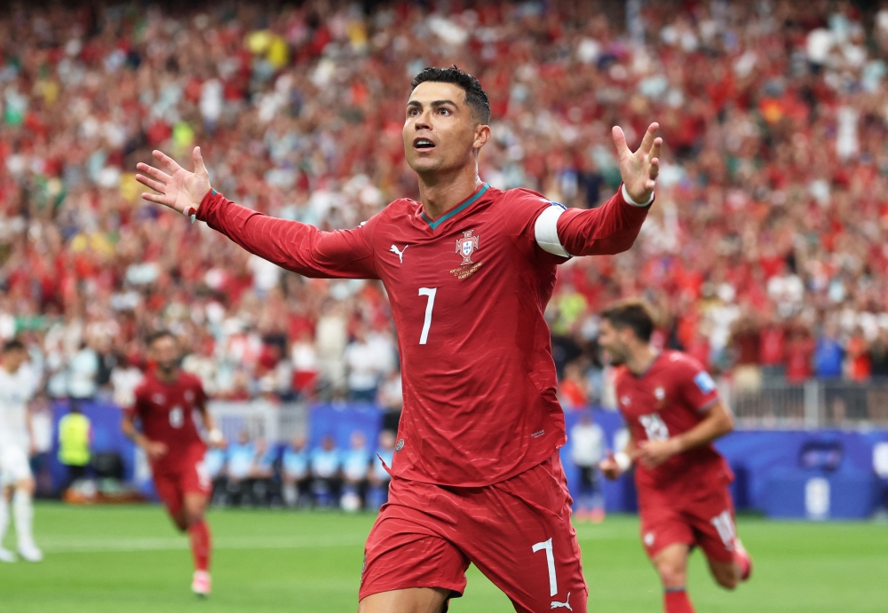  
Portugal's Cristiano Ronaldo celebrates scoring their third goal. — Reuters   