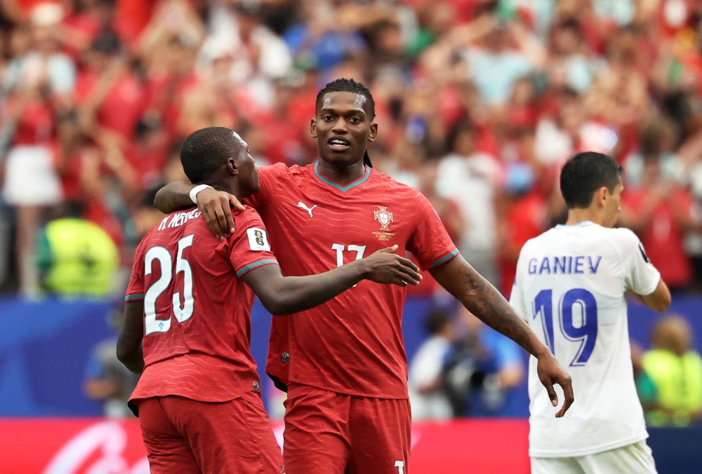  
Portugal's Rafael Leao and Nuno Mendes celebrate after the match. — Reuters   