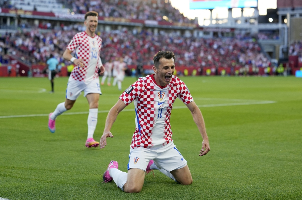 Croatia's Budimir celebrates scoring their first goal with Perisic. — Reuters
