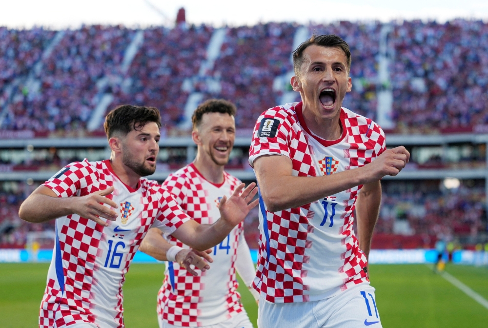 
Croatia's Budimir celebrates scoring first goal with Perisic and Baturina. — Reuters   