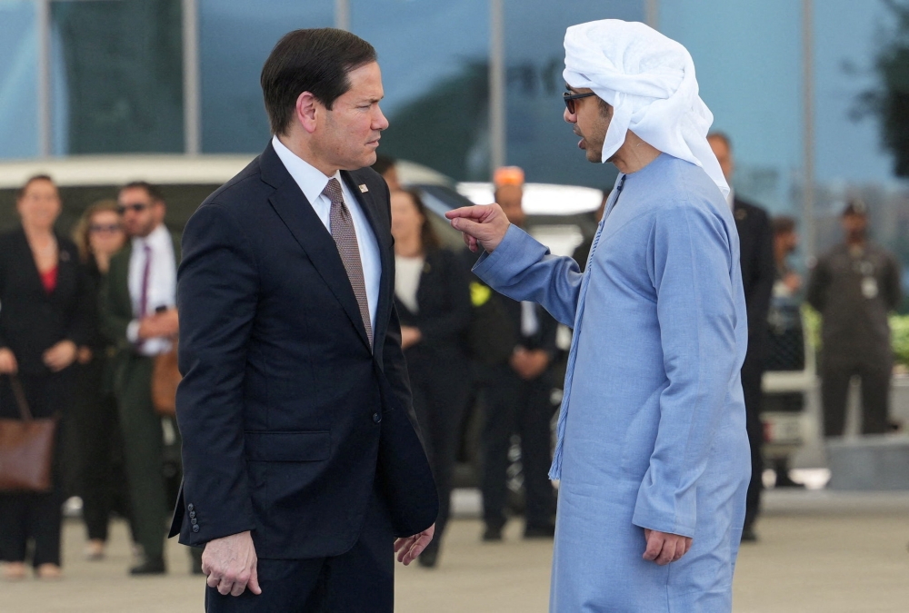U.S. Secretary of State Marco Rubio talks to the United Arab Emirates' Foreign Minister Sheikh Abdullah bin Zayed bin Sultan Al Nahyan before boarding a U.S. Air Force C-17 Globemaster III transport aircraft at Al Bateen Executive Airport, en route to Kuwait during his visit to the Middle East