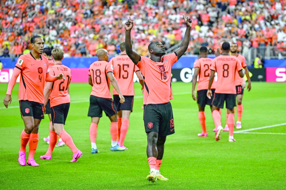 Netherlands' forward #19 Brian Brobbey (C) celebrates after scoring the opening goal during the 2026 World Cup Group F football match between the Netherlands and Sweden. — AFP