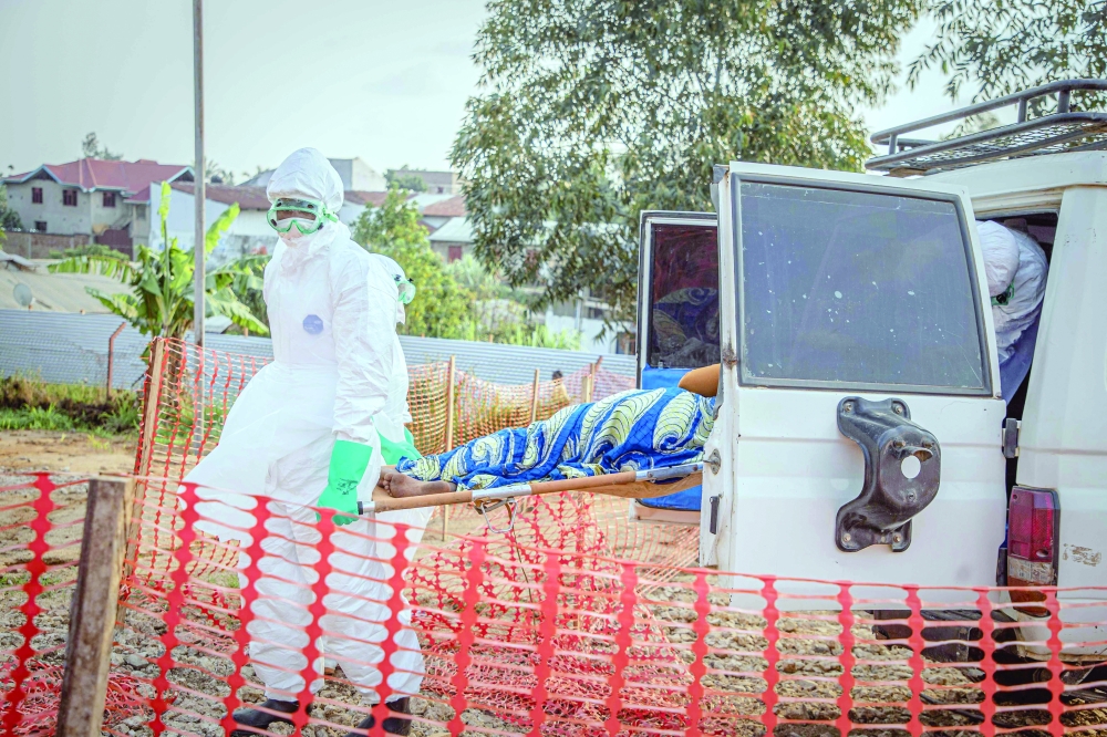 Healthcare workers carry on a stretcher a patient suffering from the Ebola virus disease from an ambulance at the Ebola Treatment Centre (ETC) in Bunia, Ituri, in the east of the Democratic Republic of Congo. — AFP